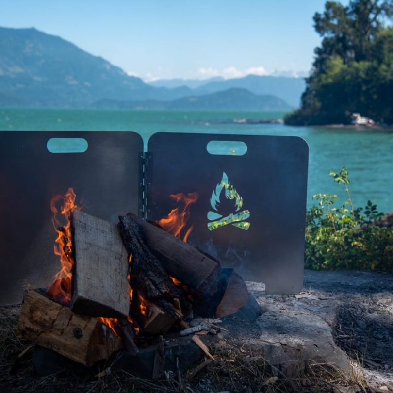 Escape to the serene woods by the lake, where "The Original Fire Reflector" takes center stage, ensuring embers stay in check. Handmade with attention to detail in Canada, this campfire accessory creates a controlled environment, allowing you to savor the wilderness without worrying about sparks. Embrace the beauty of nature, enhanced by the warm glow and protection of this innovative reflector.